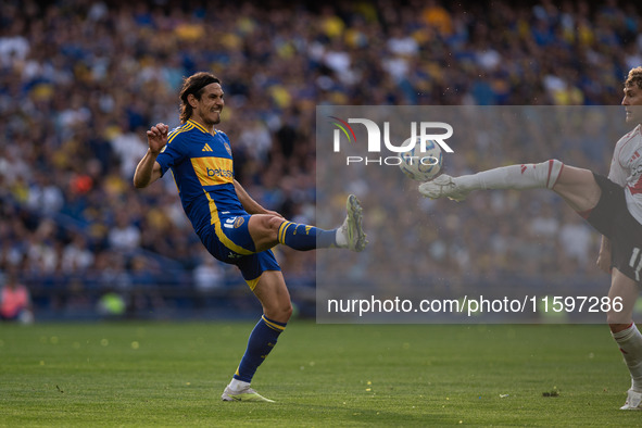 Edinson Cavani of Boca Juniors and Facundo Colidio of River Plate battle for the ball during an Argentine soccer league match at La Bomboner...