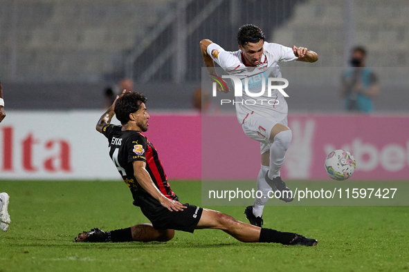 In Ta' Qali, Malta, on September 21, 2024, Benjamin Hili (R) of Balzan is challenged by Elionay Freitas Da Silva (L) of Hamrun Spartans duri...