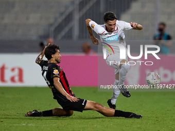 In Ta' Qali, Malta, on September 21, 2024, Benjamin Hili (R) of Balzan is challenged by Elionay Freitas Da Silva (L) of Hamrun Spartans duri...