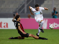 In Ta' Qali, Malta, on September 21, 2024, Benjamin Hili (R) of Balzan is challenged by Elionay Freitas Da Silva (L) of Hamrun Spartans duri...