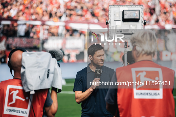 Xabi Alonso, Head Coach of Bayer 04 Leverkusen, does an interview prior to the Bundesliga match between Bayer 04 Leverkusen and VfL Wolfsbur...