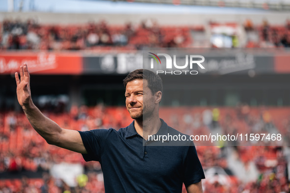 Xabi Alonso, Head Coach of Bayer 04 Leverkusen, greets fans prior to the Bundesliga match between Bayer 04 Leverkusen and VfL Wolfsburg at B...