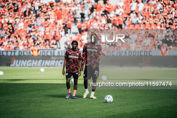 Jeremie Frimpong and Victor Boniface of Bayer 04 Leverkusen look on prior to the Bundesliga match between Bayer 04 Leverkusen and VfL Wolfsb...