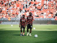 Jeremie Frimpong and Victor Boniface of Bayer 04 Leverkusen look on prior to the Bundesliga match between Bayer 04 Leverkusen and VfL Wolfsb...