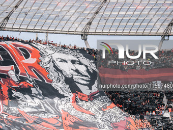 Fans of Bayer 04 Leverkusen hold a banner of Xabi Alonso, Head Coach of Bayer 04 Leverkusen, prior to the Bundesliga match between Bayer 04...