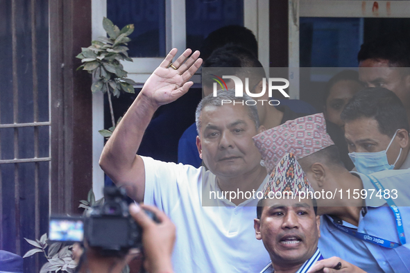 Medical entrepreneur Durga Prasai waves to the media and supporters after being arrested by the Nepal Police on charges of violating the Ele...