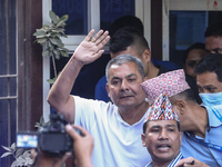 Medical entrepreneur Durga Prasai waves to the media and supporters after being arrested by the Nepal Police on charges of violating the Ele...