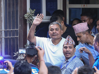 Medical entrepreneur Durga Prasai waves to the media and supporters after being arrested by the Nepal Police on charges of violating the Ele...