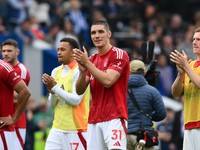 Nikola Milenkovic of Nottingham Forest applauds his team's supporters during the Premier League match between Brighton and Hove Albion and N...