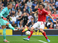 Chris Wood of Nottingham Forest puts pressure on Bart Verbruggen, Brighton goalkeeper, during the Premier League match between Brighton and...