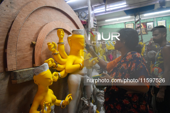 An artisan paints an idol of the Hindu goddess Durga at a workshop ahead of the Durga Puja festival in Kolkata, India, on September 22, 2024...