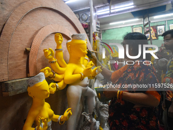 An artisan paints an idol of the Hindu goddess Durga at a workshop ahead of the Durga Puja festival in Kolkata, India, on September 22, 2024...