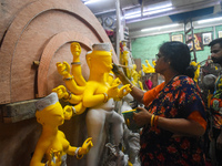 An artisan paints an idol of the Hindu goddess Durga at a workshop ahead of the Durga Puja festival in Kolkata, India, on September 22, 2024...