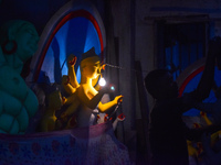 Idol makers dry a Durga idol with bulb light inside a workshop ahead of the Durga Puja festival in Kolkata, India, on September 22, 2024. (