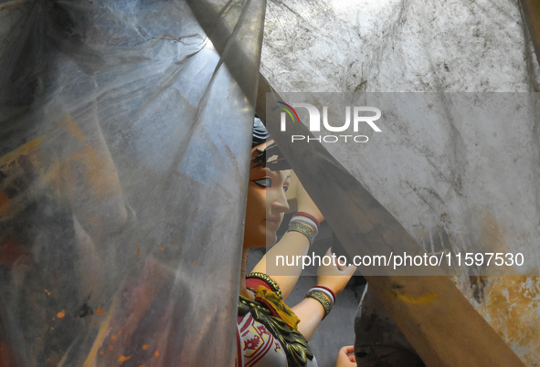 An artisan paints an idol of the Hindu goddess Durga at a workshop ahead of the Durga Puja festival in Kolkata, India, on September 22, 2024...