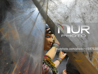 An artisan paints an idol of the Hindu goddess Durga at a workshop ahead of the Durga Puja festival in Kolkata, India, on September 22, 2024...