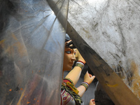 An artisan paints an idol of the Hindu goddess Durga at a workshop ahead of the Durga Puja festival in Kolkata, India, on September 22, 2024...