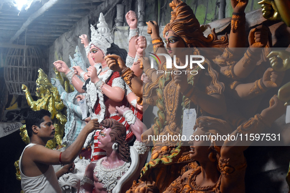 An artisan paints an idol of the Hindu goddess Durga at a workshop ahead of the Durga Puja festival in Kolkata, India, on September 22, 2024...