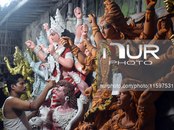 An artisan paints an idol of the Hindu goddess Durga at a workshop ahead of the Durga Puja festival in Kolkata, India, on September 22, 2024...