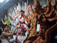 An artisan paints an idol of the Hindu goddess Durga at a workshop ahead of the Durga Puja festival in Kolkata, India, on September 22, 2024...