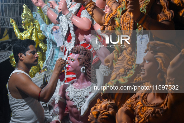 An artisan paints an idol of the Hindu goddess Durga at a workshop ahead of the Durga Puja festival in Kolkata, India, on September 22, 2024...