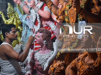 An artisan paints an idol of the Hindu goddess Durga at a workshop ahead of the Durga Puja festival in Kolkata, India, on September 22, 2024...