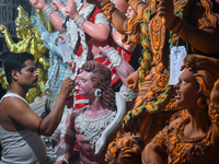 An artisan paints an idol of the Hindu goddess Durga at a workshop ahead of the Durga Puja festival in Kolkata, India, on September 22, 2024...