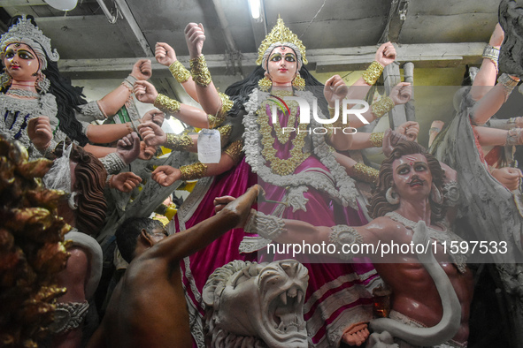 An artisan paints an idol of the Hindu goddess Durga at a workshop ahead of the Durga Puja festival in Kolkata, India, on September 22, 2024...