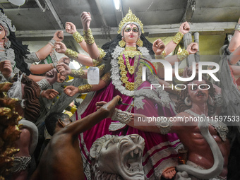 An artisan paints an idol of the Hindu goddess Durga at a workshop ahead of the Durga Puja festival in Kolkata, India, on September 22, 2024...