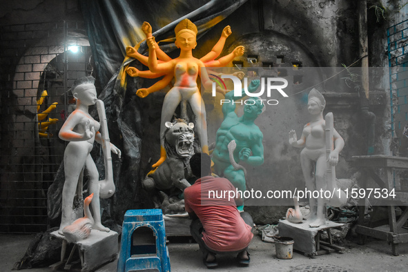 An idol maker makes a Durga idol inside a workshop ahead of the Durga Puja festival in Kolkata, India, on September 22, 2024. 