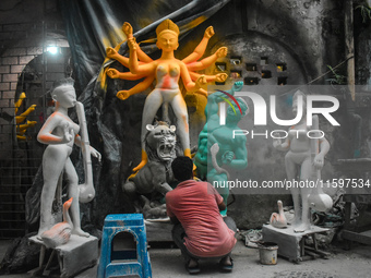 An idol maker makes a Durga idol inside a workshop ahead of the Durga Puja festival in Kolkata, India, on September 22, 2024. (