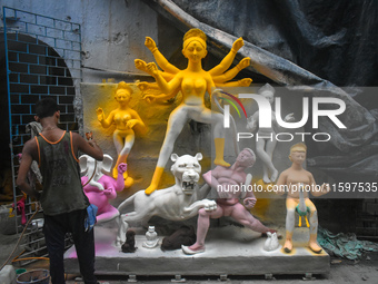 An idol maker paints an idol of the Hindu goddess Durga at a workshop ahead of the Durga Puja festival in Kolkata, India, on September 22, 2...