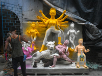 An idol maker paints an idol of the Hindu goddess Durga at a workshop ahead of the Durga Puja festival in Kolkata, India, on September 22, 2...