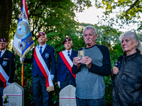 A son shows a photo of his father who fought in WWII during the Airborne Memorial Service held at War Cemetery in Oosterbeek, Netherlands, o...