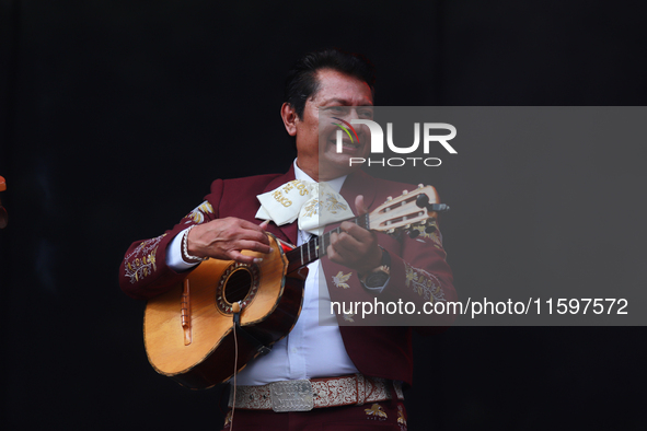 A member of Mariachi Los Gallos de Mexico performs during the Maraton de Mariachis de la Ciudad de Mexico at Zocalo main square, whose objec...