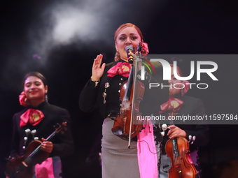 A member of Mariachi Femenil Amazonas performs during the Maraton de Mariachis de la Ciudad de Mexico at Zocalo main square, which aims to p...