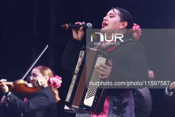 A member of Mariachi Femenil Amazonas performs during the Maraton de Mariachis de la Ciudad de Mexico at Zocalo main square, which aims to p...