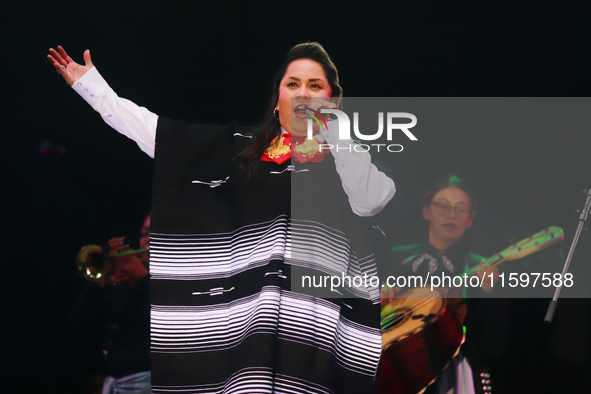 Vivir Quintana with Mariachi Mexicana Hermosa performs during the Maraton de Mariachis de la Ciudad de Mexico at Zocalo main square, whose o...