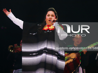 Vivir Quintana with Mariachi Mexicana Hermosa performs during the Maraton de Mariachis de la Ciudad de Mexico at Zocalo main square, whose o...