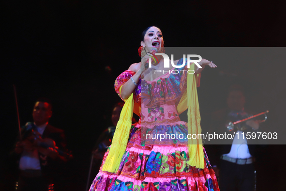 Rosy Arango with the Mariachi Internacional Estrella de Oro performs during the Maraton de Mariachis de la Ciudad de Mexico at Zocalo main s...