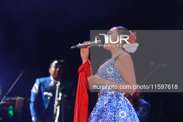 Valeria Cuevas with the Mariachi Real de la Montana performs during the Maraton de Mariachis de la Ciudad de Mexico at Zocalo main square, w...