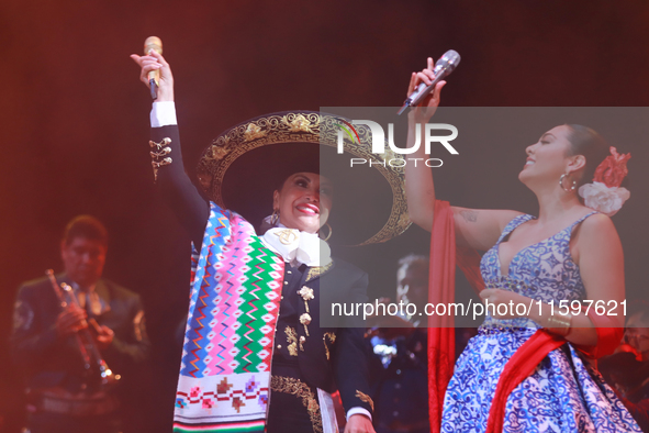 Valeria Cuevas and Aida Cuevas with the Mariachi Real de la Montana perform during the Maraton de Mariachis de la Ciudad de Mexico at Zocalo...