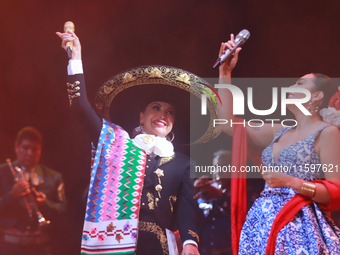 Valeria Cuevas and Aida Cuevas with the Mariachi Real de la Montana perform during the Maraton de Mariachis de la Ciudad de Mexico at Zocalo...