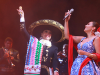 Valeria Cuevas and Aida Cuevas with the Mariachi Real de la Montana perform during the Maraton de Mariachis de la Ciudad de Mexico at Zocalo...