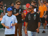 Yuki Tsunoda of Japan and the Visa Cash App RB F1 Team and Lewis Hamilton of the United Kingdom and the Mercedes-AMG Petronas F1 Team are pi...