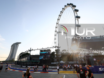 A general view of the sunset behind the Singapore Flyer during the drivers' parade ahead of the F1 Grand Prix of Singapore at Marina Bay Str...