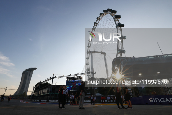 A general view of the sunset behind the Singapore Flyer during the drivers' parade ahead of the F1 Grand Prix of Singapore at Marina Bay Str...