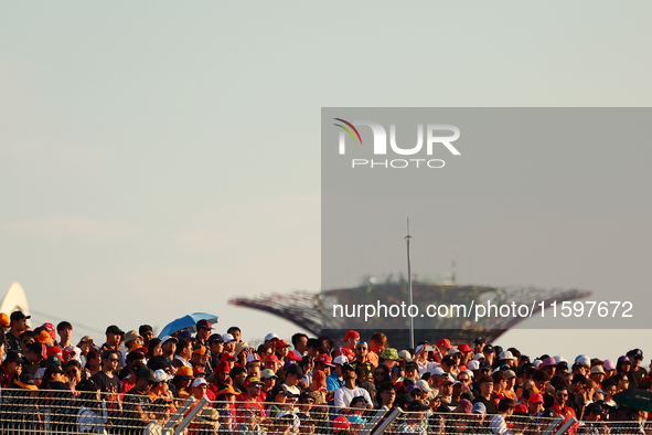 Fans watch during the drivers' parade ahead of the F1 Grand Prix of Singapore at Marina Bay Street Circuit in Singapore, Singapore, on Septe...