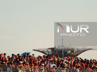 Fans watch during the drivers' parade ahead of the F1 Grand Prix of Singapore at Marina Bay Street Circuit in Singapore, Singapore, on Septe...