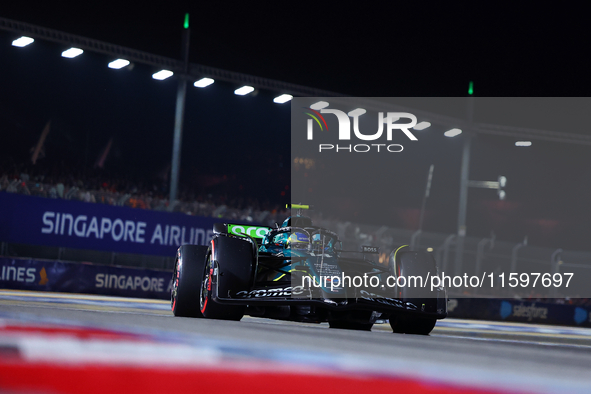 Fernando Alonso of Spain and Aston Martin Aramco F1 Team drives to the grid ahead of the F1 Grand Prix of Singapore at Marina Bay Street Cir...